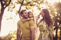 Happy family with little girl walking trough nature. Royalty Free Stock Photo