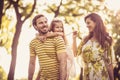 Happy family with little girl walking trough nature. Royalty Free Stock Photo