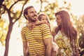 Happy family with little girl walking trough nature. Royalty Free Stock Photo