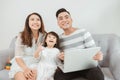 Happy family with little kids enjoying using application on laptop together Royalty Free Stock Photo