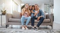 Happy family, living room and portrait of a mother, dad and girl children smile on a home sofa. Relax, hug and parent