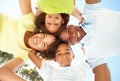 Happy Family Looking Down Into Camera In Park