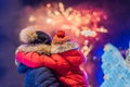 Happy family looking fireworks in the evening sky. fireworks new year, christmas. Crazy 2020 is over, it`s 2021