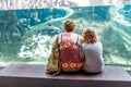 happy family looking at fish in a aquarium in Cosmocaixa museum