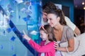 Happy family looking at fish tank Royalty Free Stock Photo