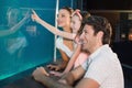 Happy family looking at fish tank Royalty Free Stock Photo