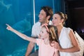 Happy family looking at fish tank Royalty Free Stock Photo