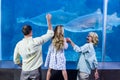 Happy family looking at the fish tank Royalty Free Stock Photo