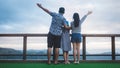 Happy family looking view of mountain at sunset. Father, mother and daughter having fun and enjoying journey Royalty Free Stock Photo