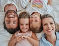 Happy family, love and above morning smile with parents and children lying and happy in bedroom for fun together at home Royalty Free Stock Photo