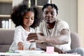 Happy family love bonding, African father and daughter girl with curly hair enjoy spending time together at home, little child kid Royalty Free Stock Photo