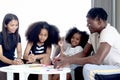 Happy family love bonding, African father mother and two daughter girls with curly hair enjoy spending time at home, little kids Royalty Free Stock Photo