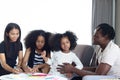 Happy family love bonding, African father mother and two daughter girls with curly hair enjoy spending time at home, little kids Royalty Free Stock Photo