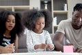 Happy family love bonding, African father and two daughter girls with curly hair enjoy spending time together at home, little Royalty Free Stock Photo