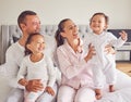 Happy family, love and morning bonding with parents, child and baby playing in the bedroom and having fun together at Royalty Free Stock Photo