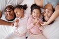 Happy family, love and morning tickling with parents and children lying and playing in bedroom for fun together at home Royalty Free Stock Photo