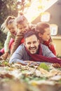 Happy family lying in autumn leaves. Royalty Free Stock Photo