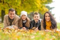 Happy family lying on a blanket outdoors on a beautiful autumn day Royalty Free Stock Photo