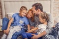 Happy family lying down on bed at home Royalty Free Stock Photo