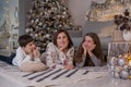 Mother and children lying on floor near christmas tree Royalty Free Stock Photo