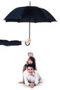 Happy family lying in studio under umbrella Royalty Free Stock Photo