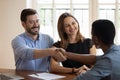 Happy family making deal, smiling husband shaking manager hand