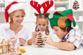 Happy family making a gingerbread cookie christmas tree Royalty Free Stock Photo