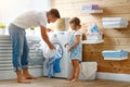 Happy family man father householder and child in laundry with Royalty Free Stock Photo