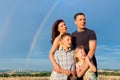 Happy family on a meadow in front of rainbow Royalty Free Stock Photo