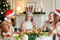 Happy family sharing gifts on Christmas morning, young and elderly couple exchanging xmas presents