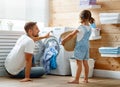 Happy family man father householder and child in laundry with