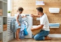 Happy family man father householder and child in laundry with Royalty Free Stock Photo