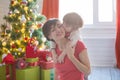 Happy family and Merry Christmas. Mother and baby son at Christmas morning at tree Royalty Free Stock Photo
