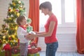 Happy family and Merry Christmas. Mother and baby son at Christmas morning at tree Royalty Free Stock Photo