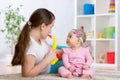 Happy family mom and baby daughter play musical toys Royalty Free Stock Photo