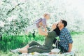 Happy family mom dad and baby daughter having fun outdoor in park smiling and laughing. Lifestyle Emotions Relationship Love