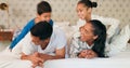 Happy family, mom and dad with children on bed, playing and bonding fun in home on weekend morning. Happiness, parents Royalty Free Stock Photo