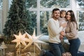 Happy family of mom, dad and little daughter spent time together on the eve of Christmas. Young perents with daughter Royalty Free Stock Photo