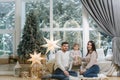 Happy family of mom, dad and little daughter spent time together on the eve of Christmas. Young perents with daughter Royalty Free Stock Photo