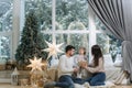 Happy family of mom, dad and little daughter spent time together on the eve of Christmas. Young perents with daughter Royalty Free Stock Photo