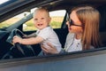 Happy family, mom and her little son, are driving in the car summer vacation, vacation Royalty Free Stock Photo