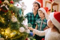 Happy family mom, son and daughter on a Christmas winter sunny morning in a decorated Christmas celebration room with a Royalty Free Stock Photo