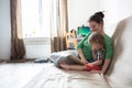 Happy family mom and son at home kitchen together read book Royalty Free Stock Photo