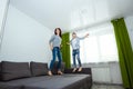 Happy family, Mom and son spend time together, fooling around on the bed, beating with pillows. Concept of happy father`s day, Royalty Free Stock Photo