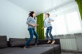 Happy family, Mom and son spend time together, fooling around on the bed, beating with pillows. Concept of happy father`s day, Royalty Free Stock Photo