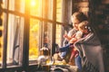 Happy family mother and baby in autumn window