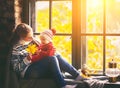 Happy family mother and baby in autumn window Royalty Free Stock Photo