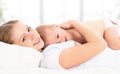 Happy family mother and baby in bed Royalty Free Stock Photo