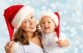 Happy family mother and baby in Christmas hats Royalty Free Stock Photo