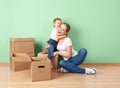 Happy family mother and baby daughter in an empty apartment with Royalty Free Stock Photo